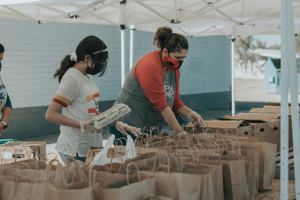 Volunteer holding supplies representing nonprofit and NGO community work