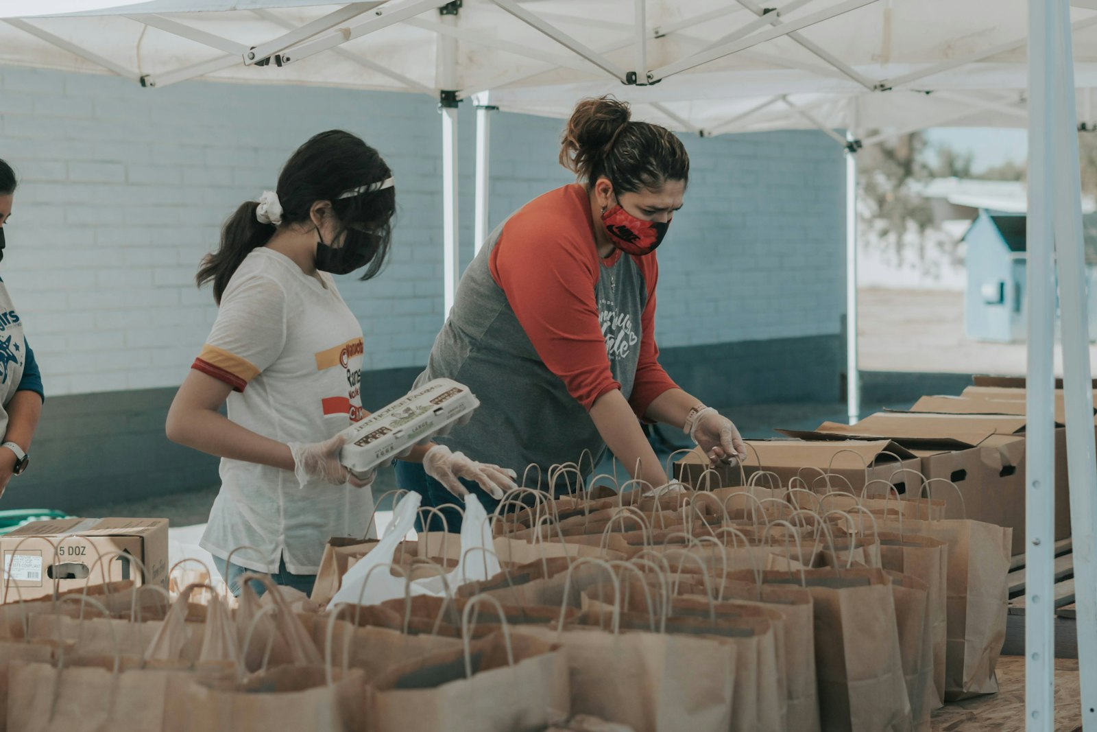 AI Website Translation for Nonprofits and NGOs Volunteer holding supplies representing nonprofit and NGO community work