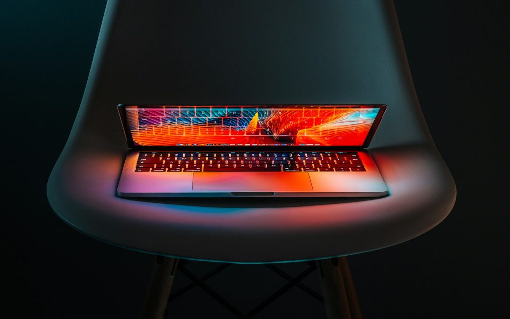 How to Translate a WordPress Multisite Network with AI Half-flipped laptop, representing AI translation of a WordPress Multisite network