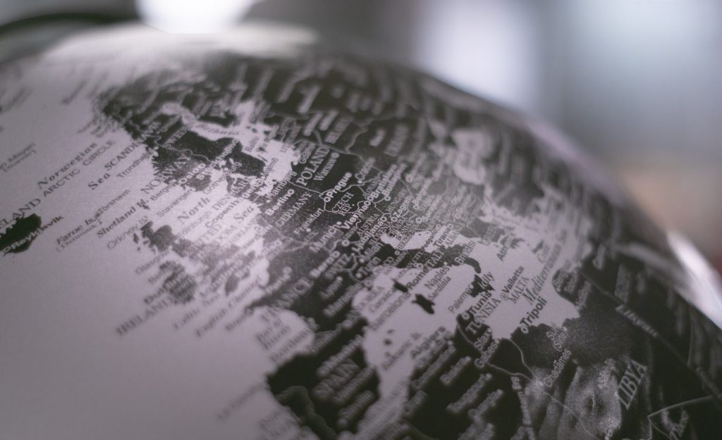 Grayscale photo of a desk globe, representing translating a WordPress website into German