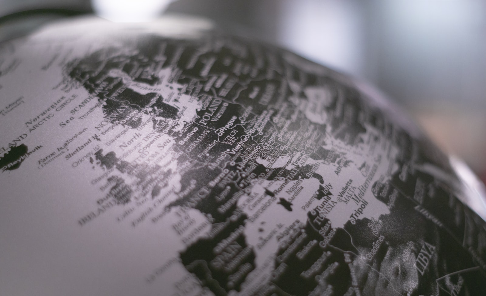 Grayscale photo of a desk globe, representing translating a WordPress website into German