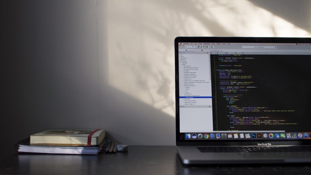 Laptop screen with code, representing AI translation of Yoast SEO metadata